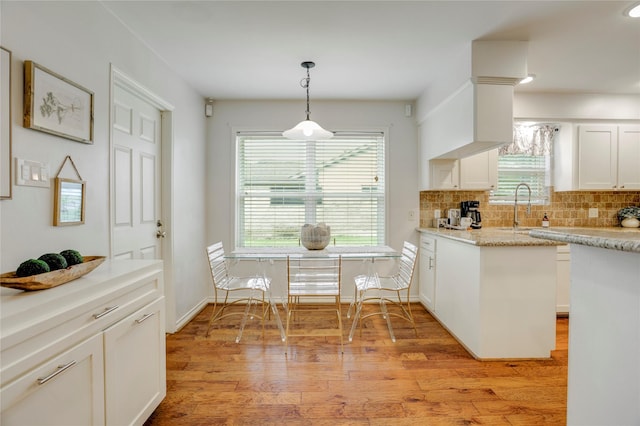 12427 Attlee Dr, Houston, TX 77077 - kitchen with a sink, backsplash, pendant lighting, light countertops, and white cabinets