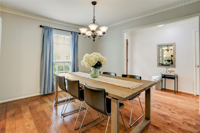 12427 Attlee Dr, Houston, TX 77077 - dining room with a chandelier, baseboards, light wood-style flooring, and crown molding