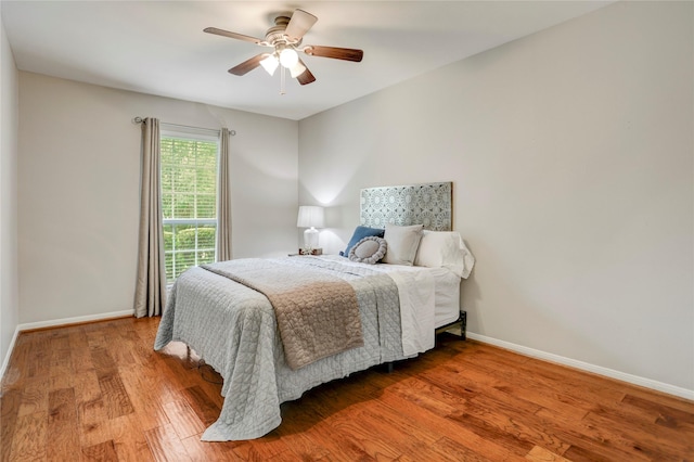 12427 Attlee Dr, Houston, TX 77077 - bedroom with baseboards, wood finished floors, and a ceiling fan