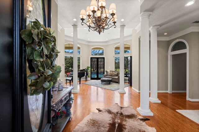 31026 Johlke Rd, Magnolia, TX 77355 - foyer featuring baseboards, crown molding, wood finished floors, recessed lighting, and ornate columns