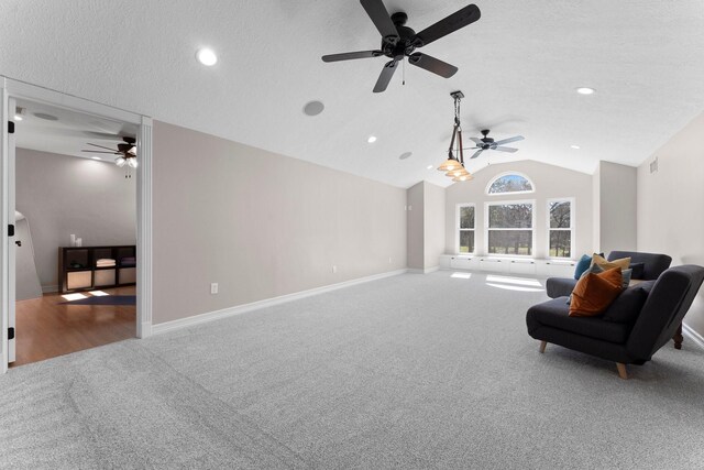 31026 Johlke Rd, Magnolia, TX 77355 - carpeted living area featuring ceiling fan, vaulted ceiling, recessed lighting, baseboards, and a textured ceiling