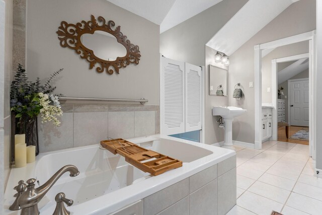 31026 Johlke Rd, Magnolia, TX 77355 - bathroom with lofted ceiling, a jetted tub, a closet, and tile patterned floors
