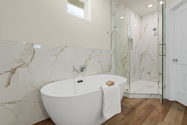 5626 Bertellis Ln, Houston, TX 77091 - full bath featuring a freestanding bath, a marble finish shower, wood finished floors, and tile walls