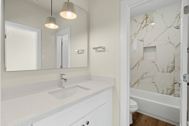 5626 Bertellis Ln, Houston, TX 77091 - bathroom with vanity, toilet, shower / washtub combination, and wood finished floors