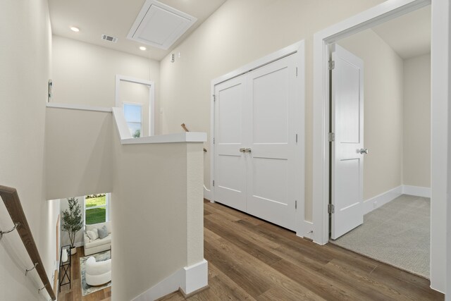 5626 Bertellis Ln, Houston, TX 77091 - hall featuring wood finished floors, an upstairs landing, attic access, recessed lighting, and baseboards