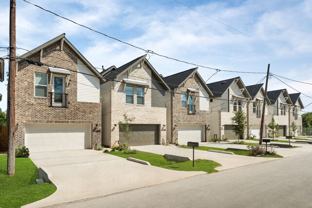 5626 Bertellis Ln, Houston, TX 77091 - view of front of property with an attached garage, brick siding, concrete driveway, and a residential view