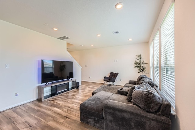 8126 Coco Bluff Dr, Cypress, TX 77433 - living area featuring wood finished floors, recessed lighting, baseboards, and stairs