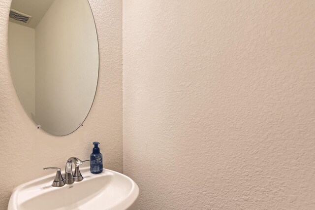 8126 Coco Bluff Dr, Cypress, TX 77433 - bathroom with a sink and a textured wall