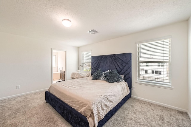 8126 Coco Bluff Dr, Cypress, TX 77433 - bedroom featuring carpet floors, baseboards, ensuite bathroom, and a textured ceiling