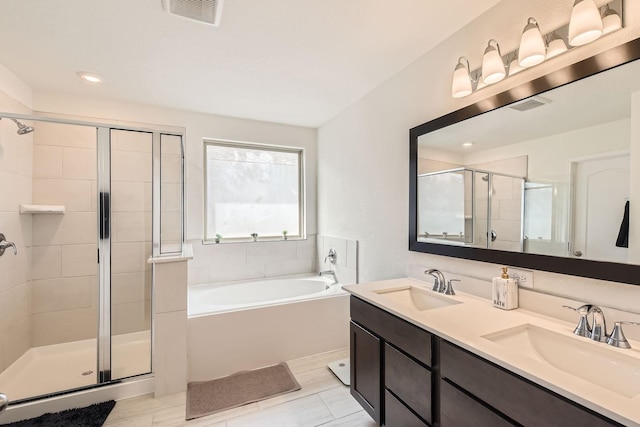 8126 Coco Bluff Dr, Cypress, TX 77433 - bathroom featuring a shower stall, a bath, double vanity, and recessed lighting
