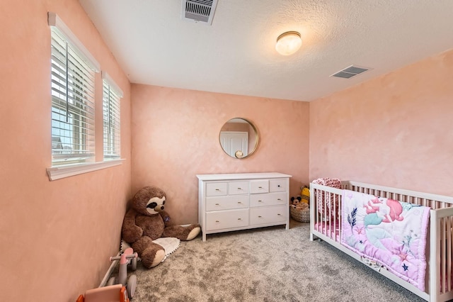 8126 Coco Bluff Dr, Cypress, TX 77433 - carpeted bedroom with a crib and a textured ceiling
