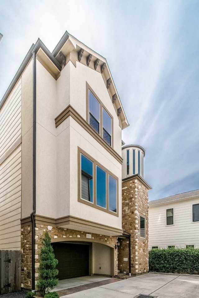 1610 Knox St Unit A, Houston, TX 77007 - view of front of home featuring stone siding, stucco siding, an attached garage, and concrete driveway