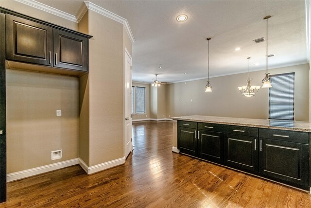 1610 Knox St Unit A, Houston, TX 77007 - kitchen with crown molding, wood finished floors, ceiling fan, a chandelier, and pendant lighting