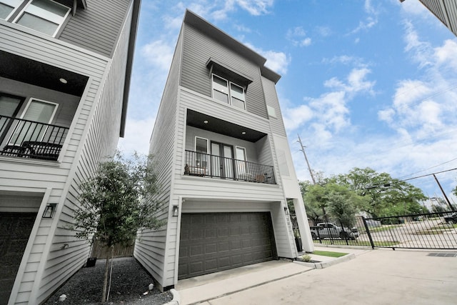 3022 Live Oak St, Houston, TX 77004 - view of front of home featuring an attached garage, a balcony, and driveway