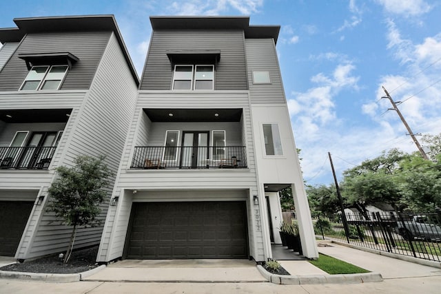3022 Live Oak St, Houston, TX 77004 - view of front facade with a balcony, an attached garage, and concrete driveway