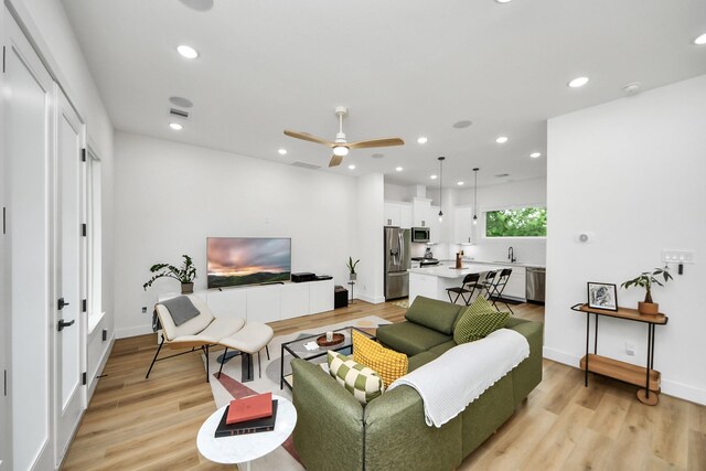 3022 Live Oak St, Houston, TX 77004 - living room featuring ceiling fan, light wood finished floors, recessed lighting, and baseboards