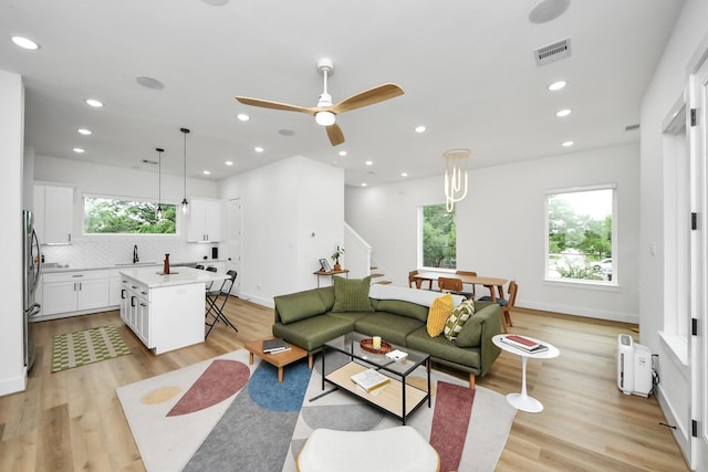 3022 Live Oak St, Houston, TX 77004 - living room featuring stairs, light wood finished floors, a ceiling fan, recessed lighting, and baseboards
