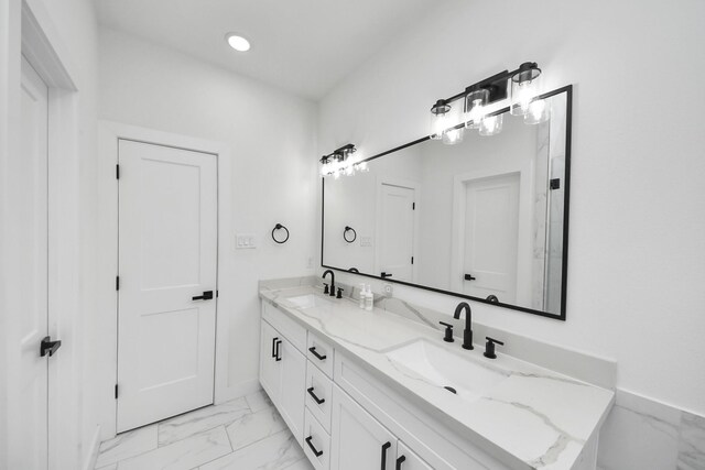 3022 Live Oak St, Houston, TX 77004 - bathroom featuring marble finish floors, double vanity, baseboards, and recessed lighting