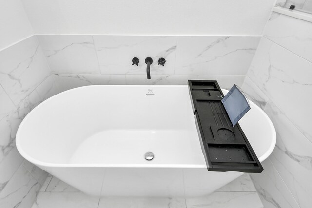 3022 Live Oak St, Houston, TX 77004 - bathroom featuring marble finish flooring and a soaking tub