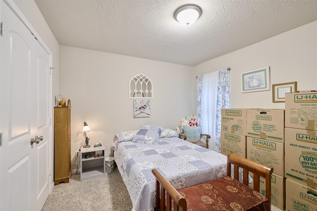 999 Arbor Gln, Conroe, TX 77303 - bedroom with carpet floors, a textured ceiling, and baseboards
