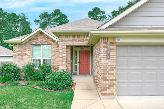 999 Arbor Gln, Conroe, TX 77303 - view of front facade with brick siding, an attached garage, and roof with shingles