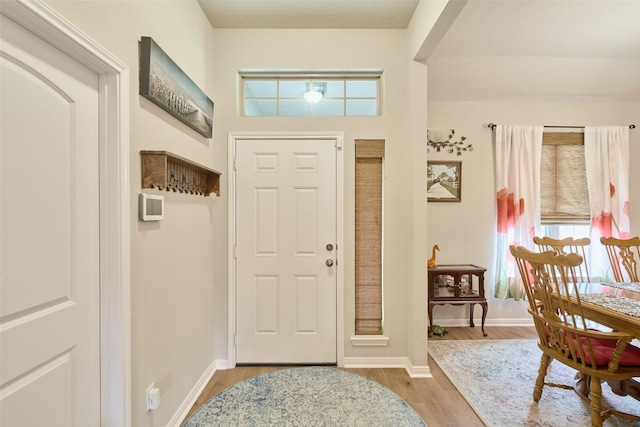 999 Arbor Gln, Conroe, TX 77303 - entrance foyer featuring healthy amount of natural light, wood finished floors, and baseboards