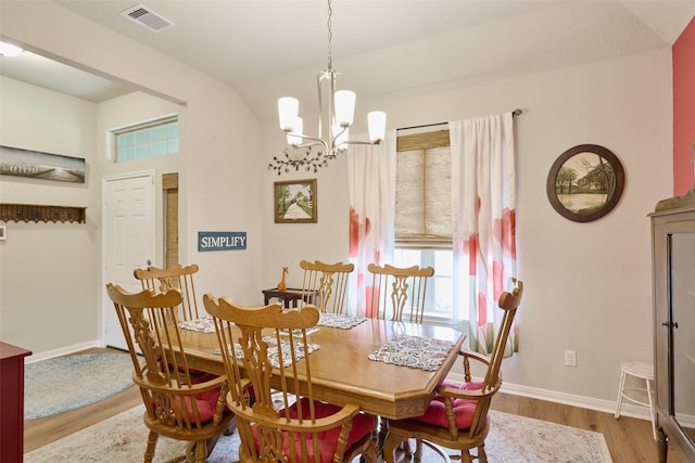 999 Arbor Gln, Conroe, TX 77303 - dining space featuring wood finished floors, a chandelier, baseboards, and vaulted ceiling