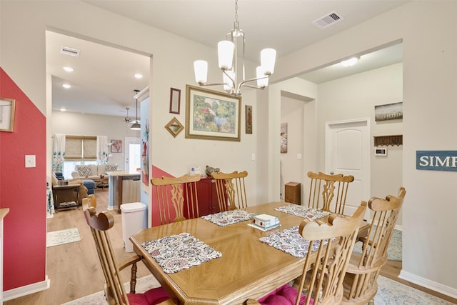 999 Arbor Gln, Conroe, TX 77303 - dining space featuring light wood-type flooring, a chandelier, baseboards, and recessed lighting