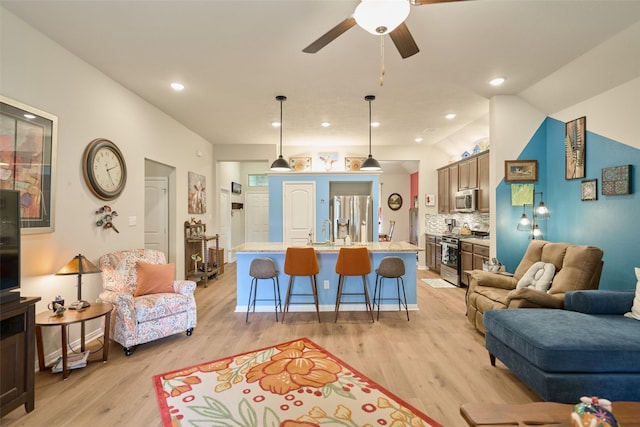 999 Arbor Gln, Conroe, TX 77303 - living room featuring light wood-type flooring, a ceiling fan, and recessed lighting