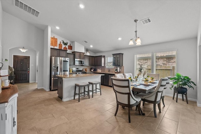 726 Rim Water Dr, Alvin, TX 77511 - dining space with recessed lighting, a chandelier, baseboards, and high vaulted ceiling