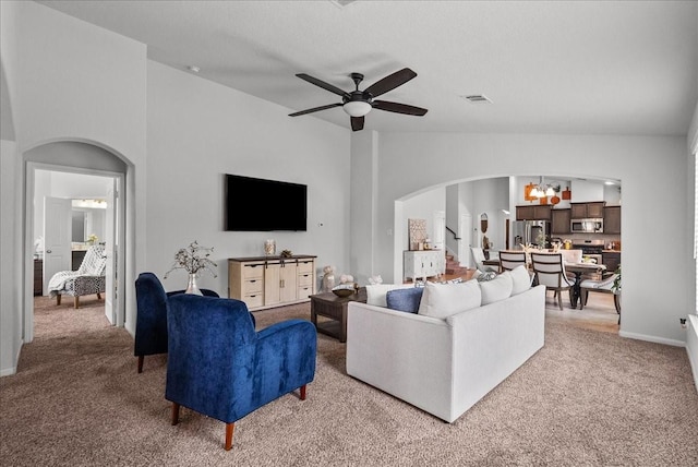 726 Rim Water Dr, Alvin, TX 77511 - living room with arched walkways, light carpet, a chandelier, and a ceiling fan