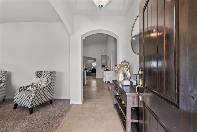 726 Rim Water Dr, Alvin, TX 77511 - hallway featuring arched walkways, baseboards, and light tile patterned floors