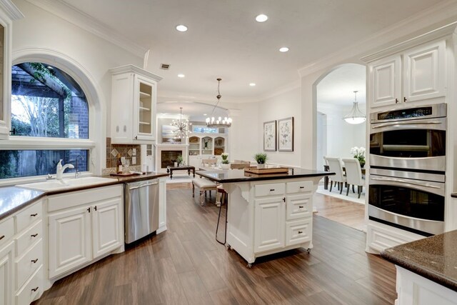 2 Fournace Gardens Dr, Bellaire, TX 77401 - kitchen with stainless steel appliances, a sink, a chandelier, recessed lighting, and white cabinets