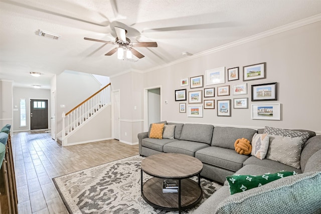 3602 Pine Stream Dr, Pearland, TX 77581 - living room featuring stairs, ceiling fan, light wood-type flooring, ornamental molding, and baseboards