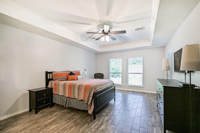 3602 Pine Stream Dr, Pearland, TX 77581 - bedroom featuring a tray ceiling, wood finished floors, baseboards, crown molding, and ceiling fan