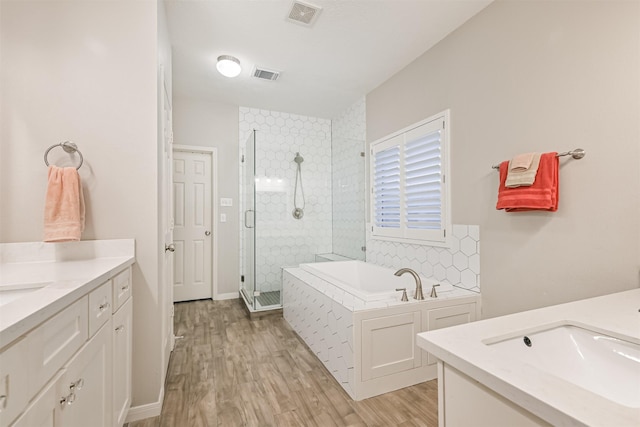 3602 Pine Stream Dr, Pearland, TX 77581 - full bathroom with two vanities, a shower stall, wood finished floors, and a bath