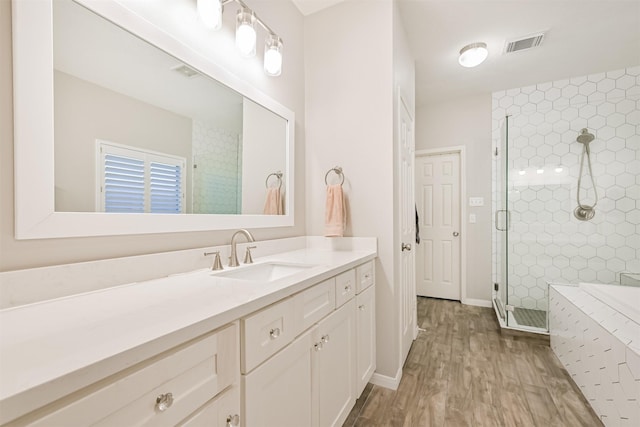 3602 Pine Stream Dr, Pearland, TX 77581 - bathroom with vanity, a stall shower, wood finished floors, and a tub