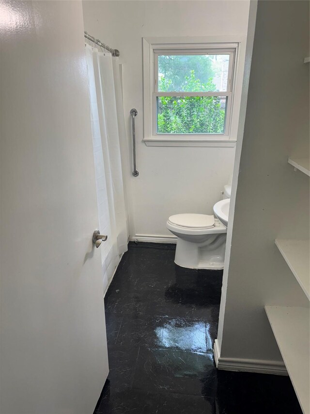 5045 Raleigh Dr, Beaumont, TX 77706 - full bath with toilet, shower / tub combo with curtain, and baseboards