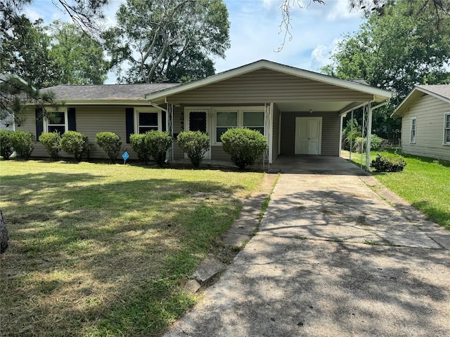 5045 Raleigh Dr, Beaumont, TX 77706 - view of front of property with a front lawn, concrete driveway, and an attached carport