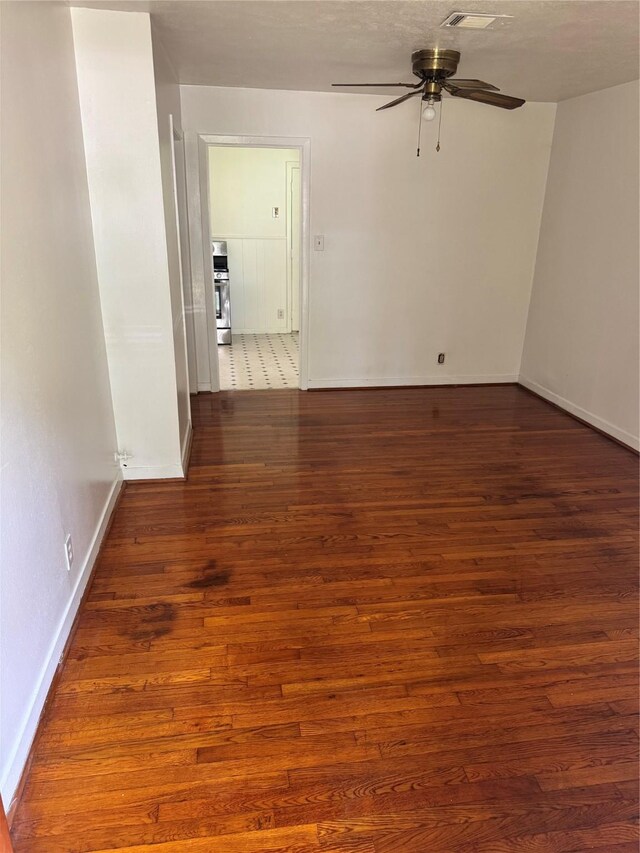 5045 Raleigh Dr, Beaumont, TX 77706 - empty room featuring a ceiling fan, wood finished floors, and baseboards