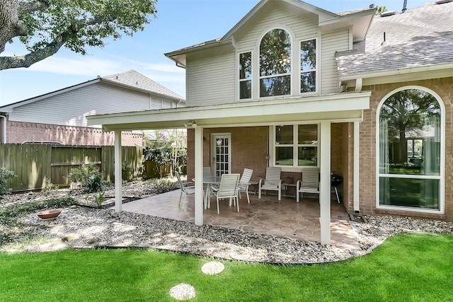 7711 Silent Star Ct, Houston, TX 77095 - rear view of house with a patio, roof with shingles, and brick siding