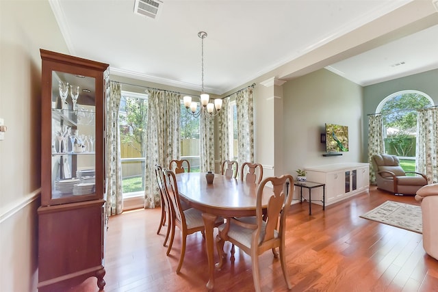 7711 Silent Star Ct, Houston, TX 77095 - dining room with a chandelier, wood finished floors, and ornamental molding