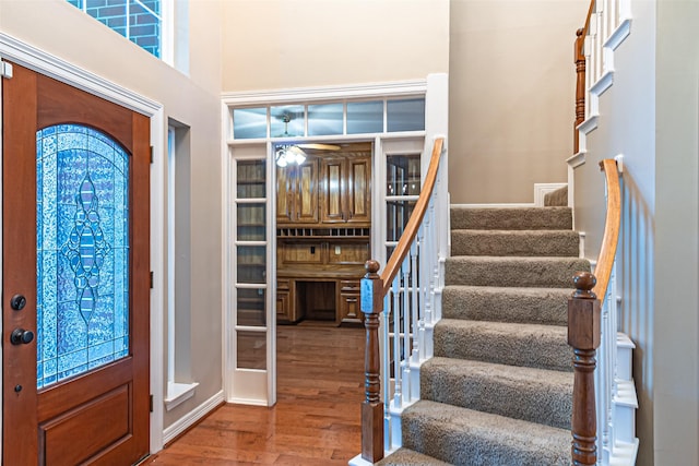 13219 Allysum Ct, Cypress, TX 77429 - entryway with wood finished floors, stairs, a ceiling fan, and a high ceiling