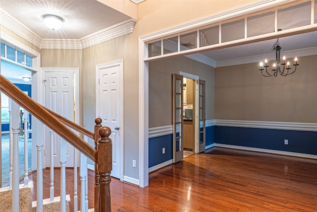 13219 Allysum Ct, Cypress, TX 77429 - foyer entrance featuring crown molding, wood finished floors, stairway, a chandelier, and baseboards