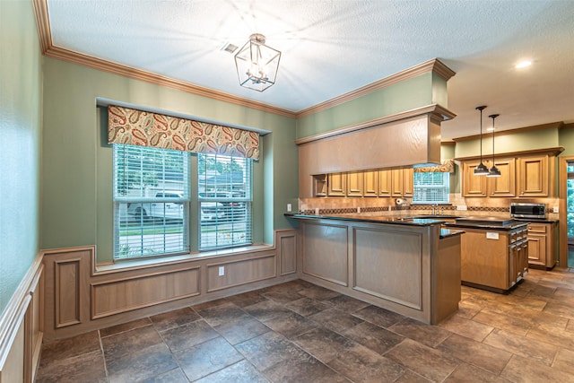 13219 Allysum Ct, Cypress, TX 77429 - kitchen featuring dark countertops, tasteful backsplash, a peninsula, crown molding, and pendant lighting