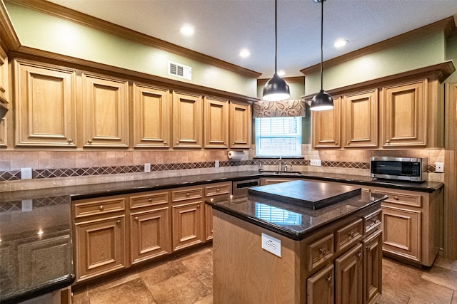 13219 Allysum Ct, Cypress, TX 77429 - kitchen featuring stainless steel microwave, a sink, crown molding, a center island, and hanging light fixtures