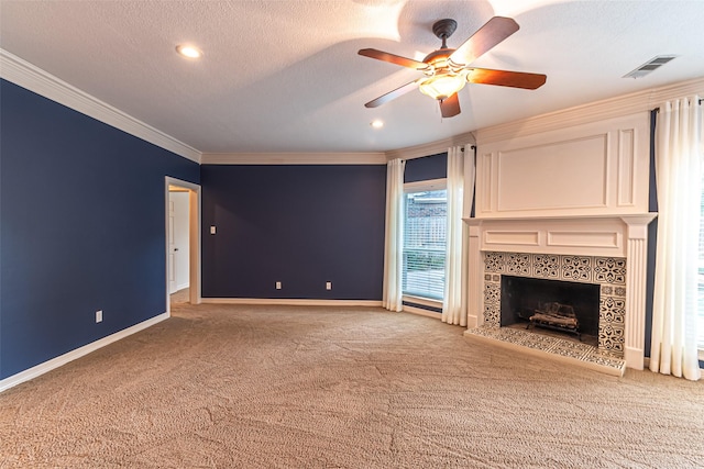 13219 Allysum Ct, Cypress, TX 77429 - unfurnished living room featuring crown molding, carpet flooring, a tiled fireplace, ceiling fan, and baseboards