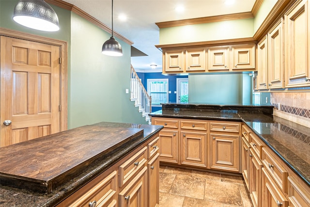 13219 Allysum Ct, Cypress, TX 77429 - kitchen featuring crown molding, decorative backsplash, dark stone counters, a peninsula, and pendant lighting