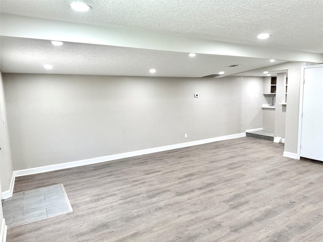3514 Mattye Maye Dr, Pasadena, TX 77503 - finished below grade area with baseboards, wood finished floors, recessed lighting, and a textured ceiling