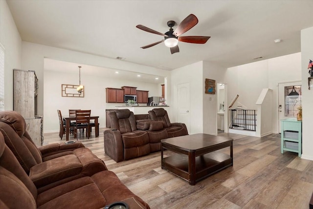 22435 Base Light Dr, Hockley, TX 77447 - living area featuring ceiling fan and light wood-style floors